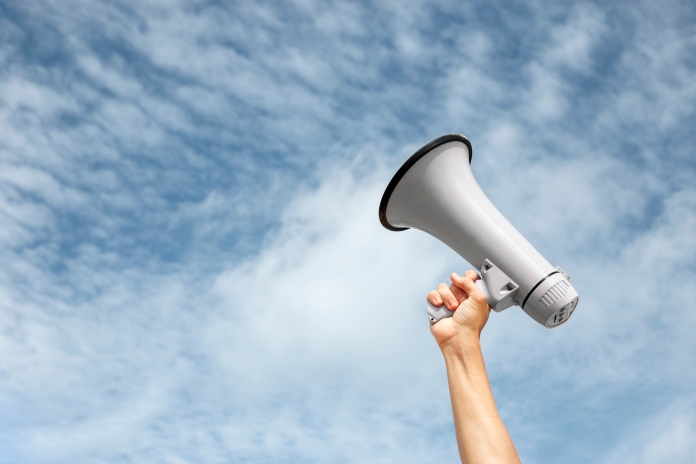 side-view-hand-holding-megaphone_23-2149864193